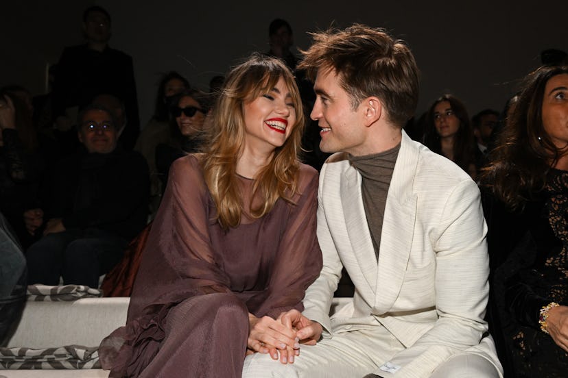 Suki Waterhouse and Robert Pattinson attend a fashion show.