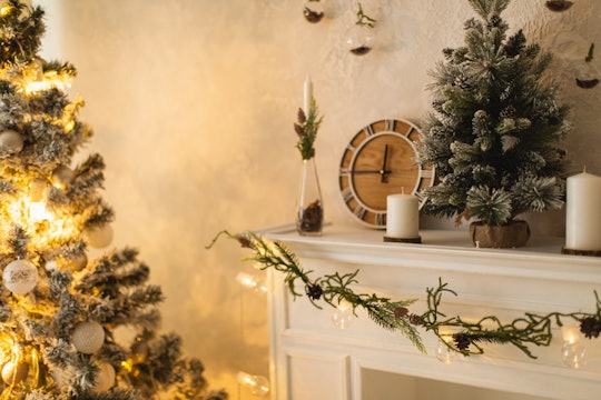 minimalist Christmas tree and decorated mantel in living room in roundup of religious instagram capt...