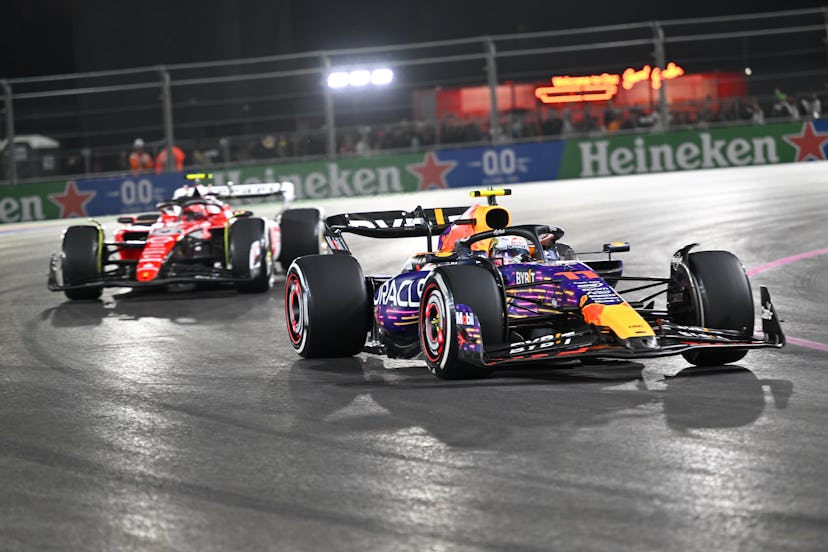 LAS VEGAS, NEVADA - NOVEMBER 19: Sergio Perez of Oracle Red Bull Racing F1 team (11) and Charles Lec...