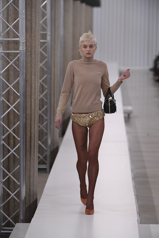 Emma Corrin walks the runway during the Miu Miu Womenswear Fall Winter 2023-2024 show in sequin unde...