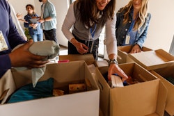 Close up shot of diverse group of people volunteering at the volunteer center. They are working as a...