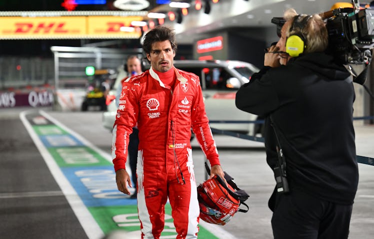 Ferrari's Spanish driver Carlos Sainz Jr., returns to the pit after an accident during the first pra...