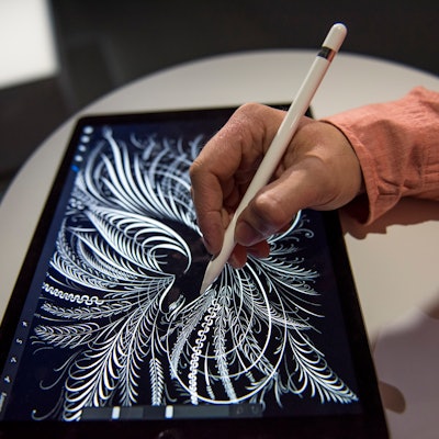 An exhibitor demonstrates the new Apple Pencil with the Apple Inc. iPad Pro tablet computer after a ...
