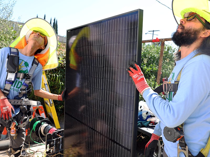 POMONA, CALIFORNIA - OCTOBER 19: GRID Alternatives employees Jimmy Chit Ming Cheung (L) and Edward A...