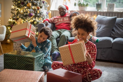 happy kids opening presnts at christmas; what to text on christmas