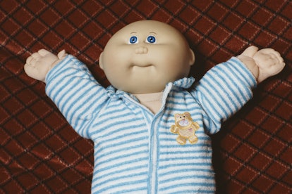 A Cabbage Patch Doll, from creator Xavier Roberts wearing a blue and white sleep suite is seen at a ...