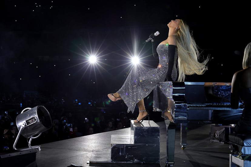 Beyoncé performs at a piano on the Renaissance Tour. 