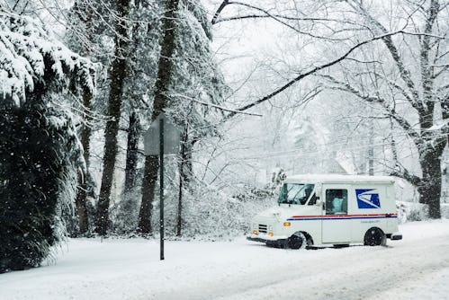 MOORESTOWN, NEW JERSEY, UNITED STATES - 2014/02/03: Mail delivery truck during a winter snow storm. ...