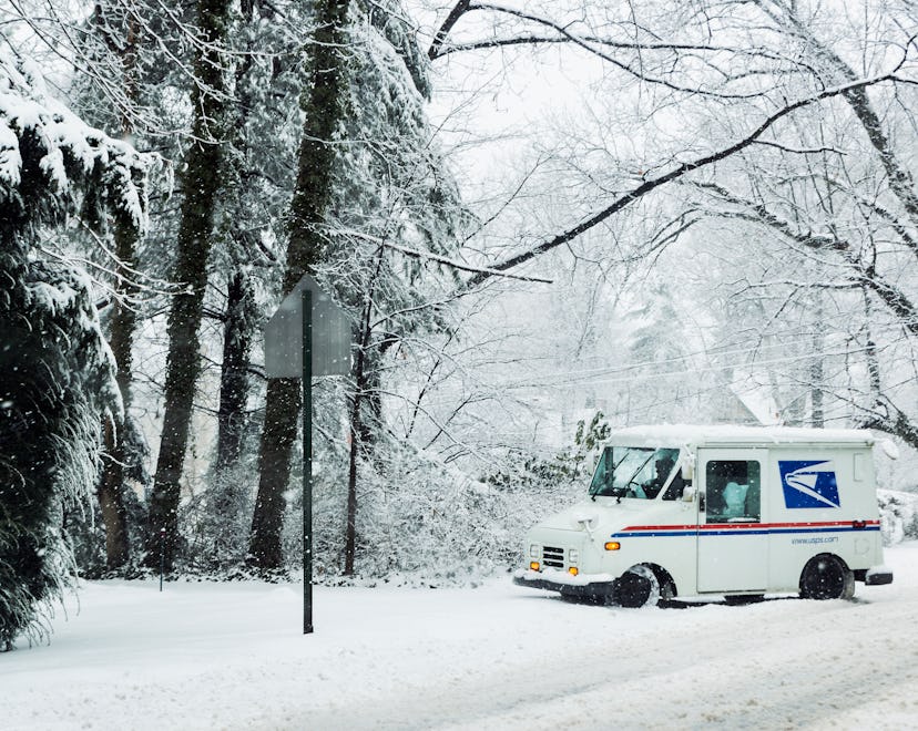 MOORESTOWN, NEW JERSEY, UNITED STATES - 2014/02/03: Mail delivery truck during a winter snow storm. ...