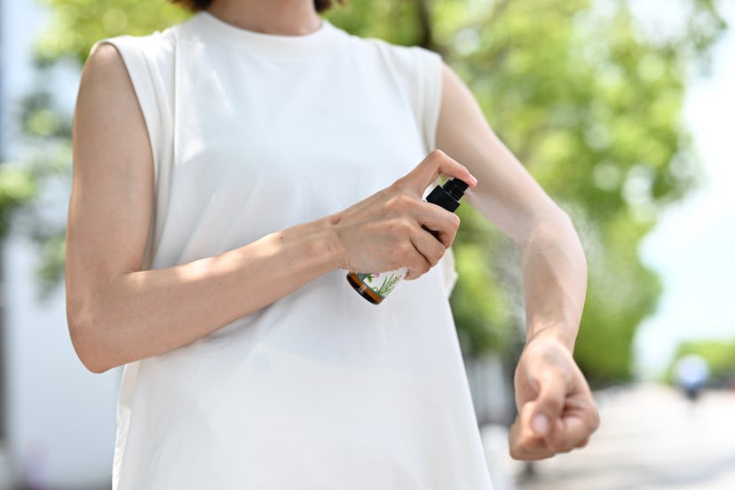 Japanese woman using insect repellent