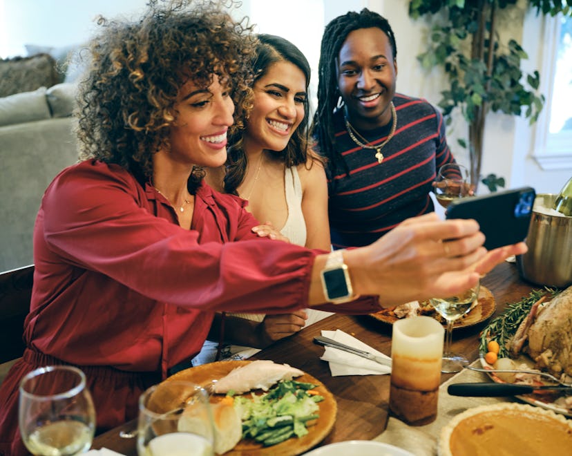 A group of friends celebrating Thanksgiving dinner together in a home.