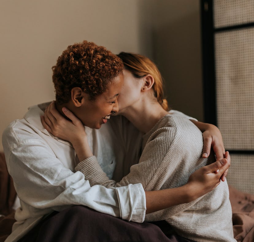 a lesbian couple whispering dirty talk phrases into each other's ears