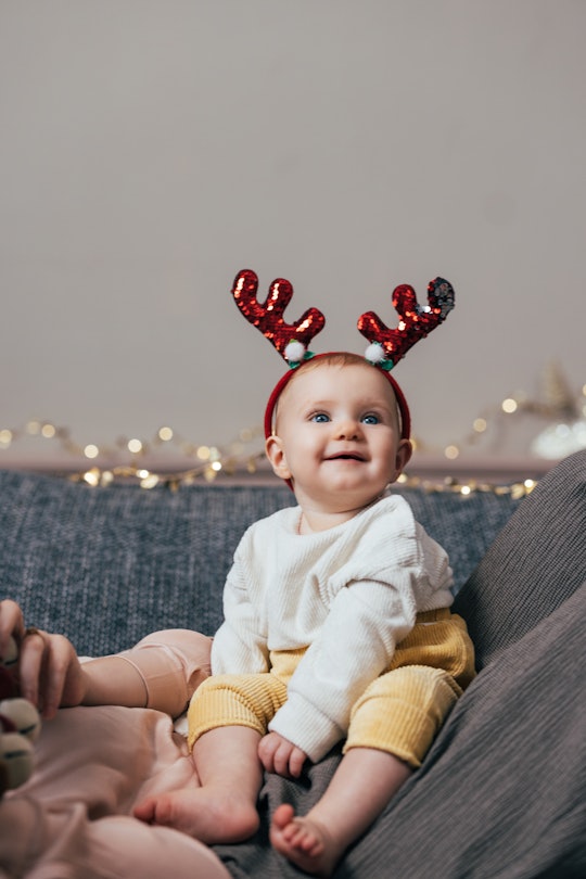 baby's first christmas wearing cute glittery reindeer antlers