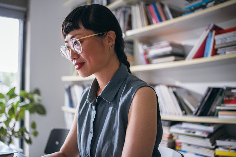 A smiling Japanese entrepreneur being busy.