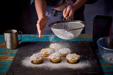 Close-up of a woman sieving icing sugar onto mince pies, taken on November 3, 2020. (Photo by Phil B...