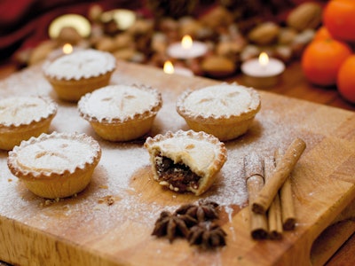 Festive scene with mince pies alongside tangerines, nuts and cinnamon sticks, taken on October 19, 2...