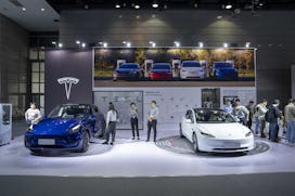 A Model Y car and Model 3 car at the Tesla Inc. booth during the World Internet of Things Exposition...