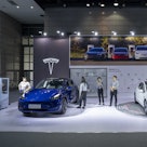 A Model Y car and Model 3 car at the Tesla Inc. booth during the World Internet of Things Exposition...