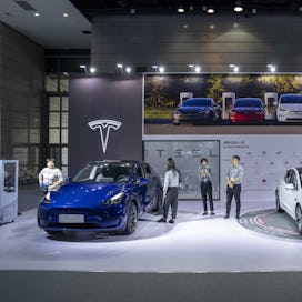 A Model Y car and Model 3 car at the Tesla Inc. booth during the World Internet of Things Exposition...