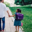 Cute girl with her father on their way to school