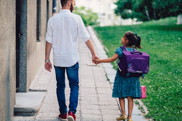 Cute girl with her father on their way to school