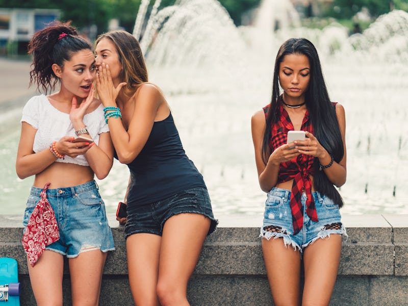 Girls hanging outside in the city park and gossiping