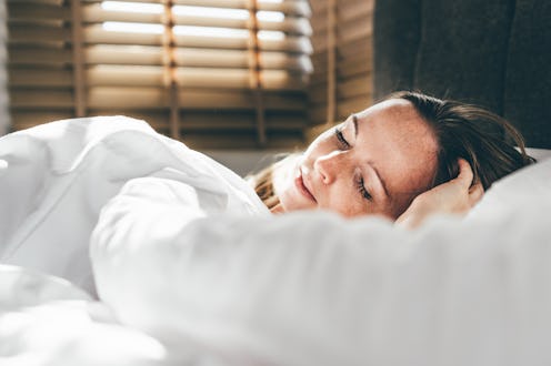 Beautiful young woman sleeps in a comfortable bed.