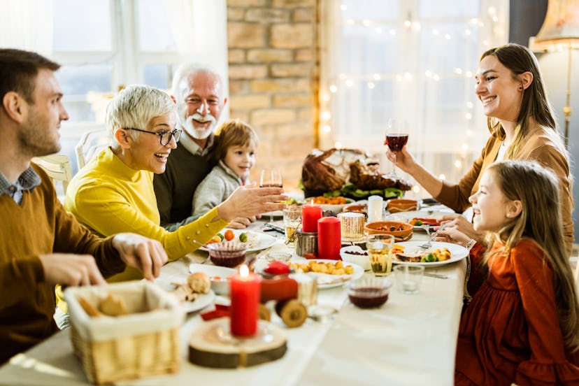 Happy family enjoying in conversation during Thanksgiving at dining table, in a story about helping ...