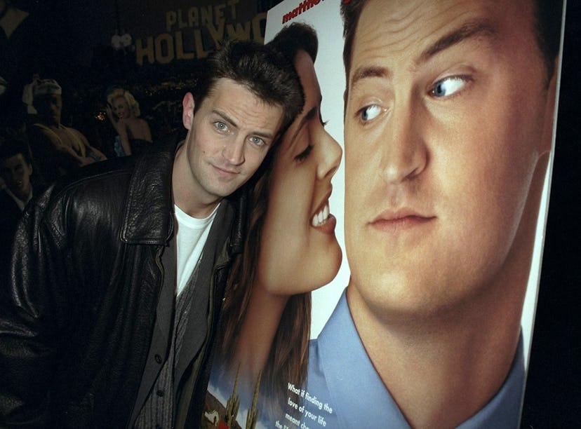 Matthew Perry in front of a ‘Fools Rush In’ poster. Photo via Getty Images