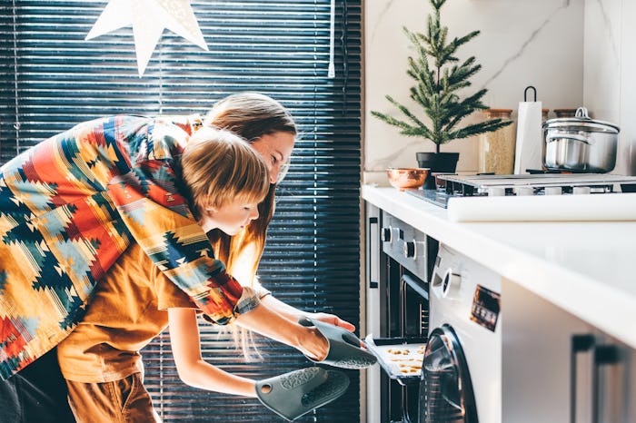 Happy mother and son baking Christmas cookies.