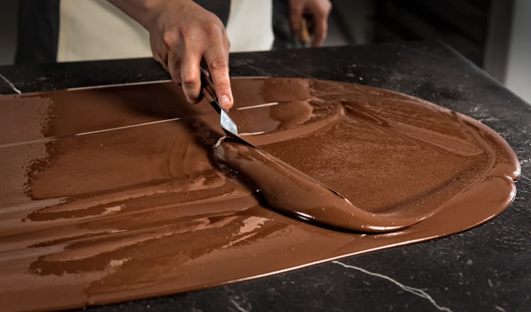 Chef Jose Ramon Castillo is pictured during the chocolate tempering process (spread the chocolate on...