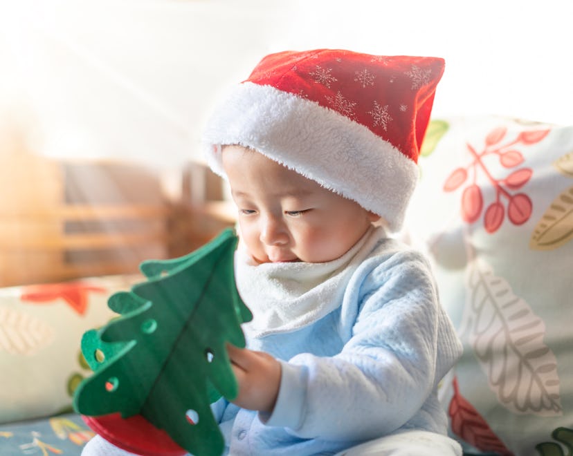 Christmas baby holding a present.