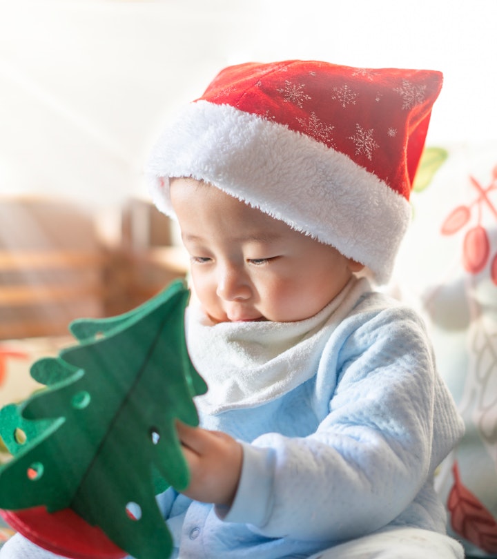 Christmas baby holding a present.