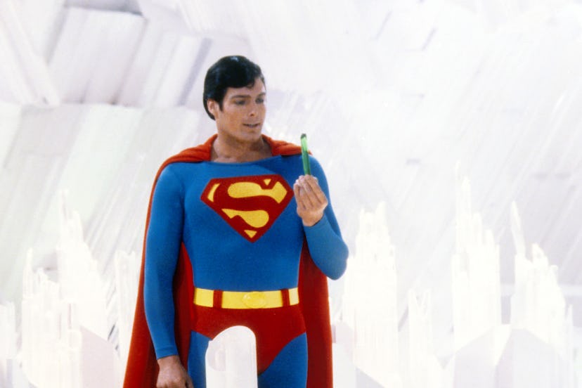 Superman, played by American actor Christopher Reeve (1952 - 2004), holds a green crystal at the For...