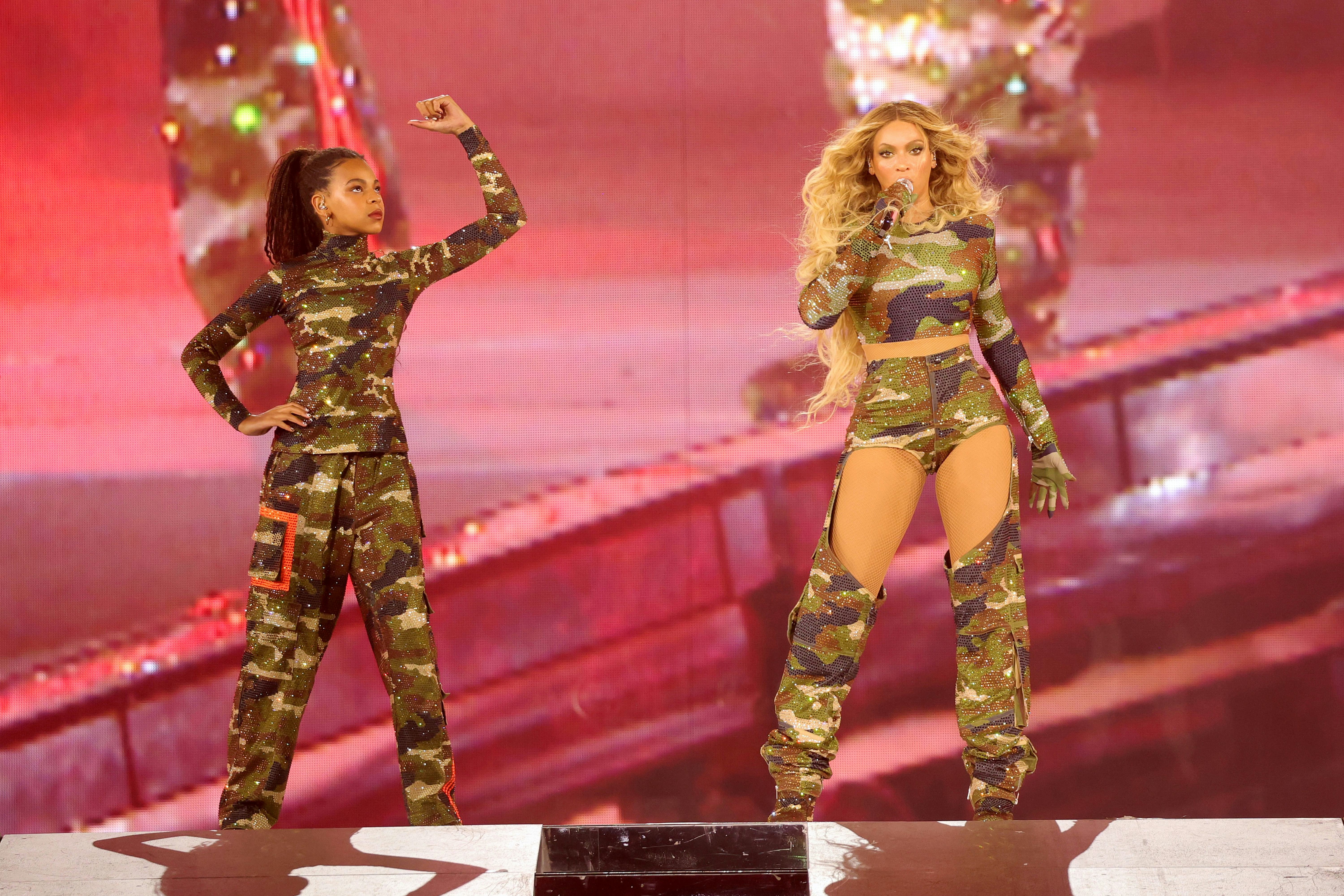 Blue Ive Carter and Beyoncé perform onstage.