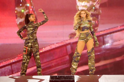 Blue Ive Carter and Beyoncé perform onstage.