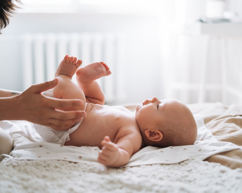 baby boy lying on white blanket at home in roundup of beautiful new years baby names
