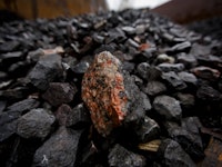 Stockpiles of rocks containing uranium ore sit in an outdoor storage area at the Rozna uranium mine,...