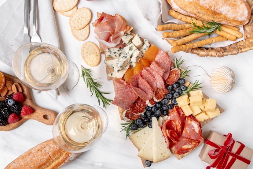 Charcuterie board italian food antipasti prosciutto ham, salami and cheese appetizers served in the ...