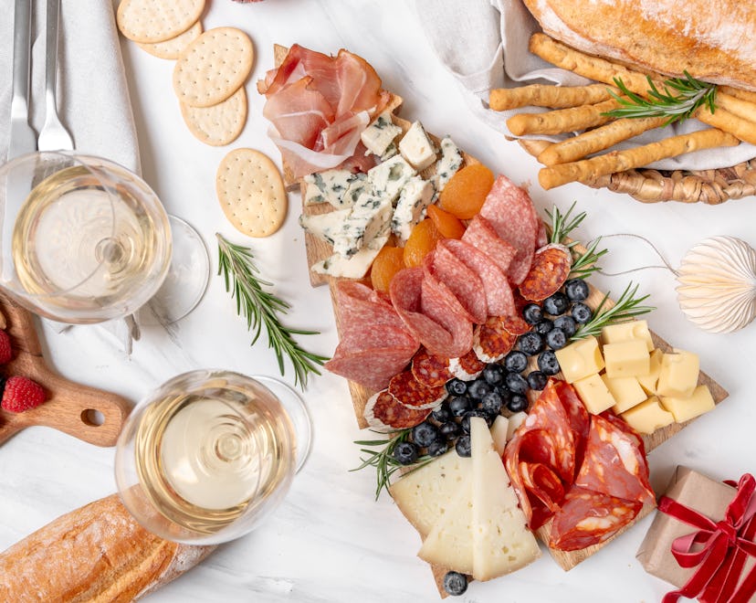 Charcuterie board italian food antipasti prosciutto ham, salami and cheese appetizers served in the ...
