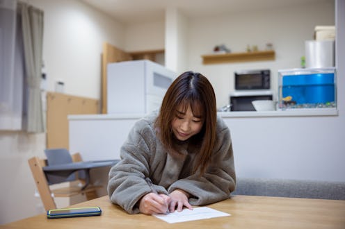 Woman working at home. Having lunch at home.