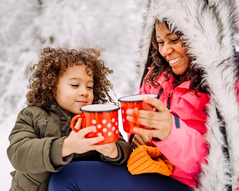 Mother and son drinking tea on a cold snowy day