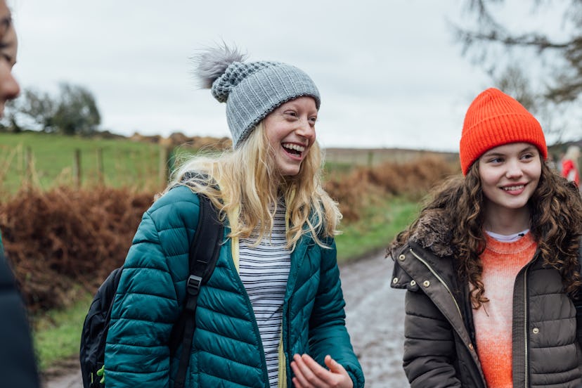 Front view waist up in Rothbury's woodlands, a group of female student teenagers are on an education...