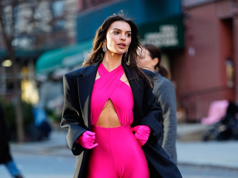 Emily Ratajkowski wore a hot pink, cut-out catsuit while filming a Maybelline commercial