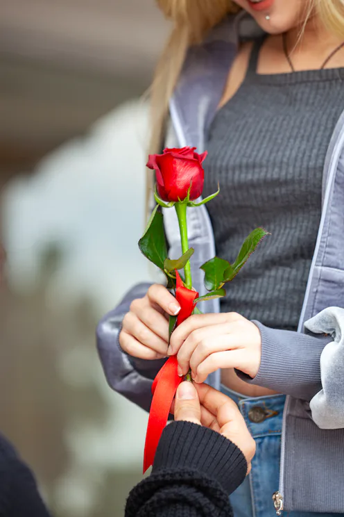 Young man hugging his girlfriend and surprising her.