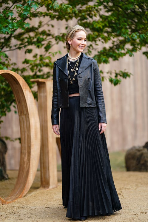 PARIS, FRANCE - SEPTEMBER 24: Jennifer Lawrence wears a black leather jacket, a golden necklace, a b...