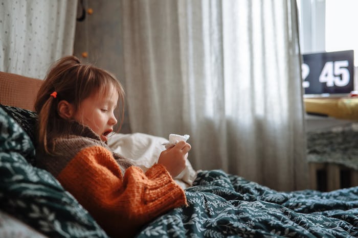 Sick Child Girl in Sweater Resting in Bed with a Tissue, how long are you contagious for with cold, ...