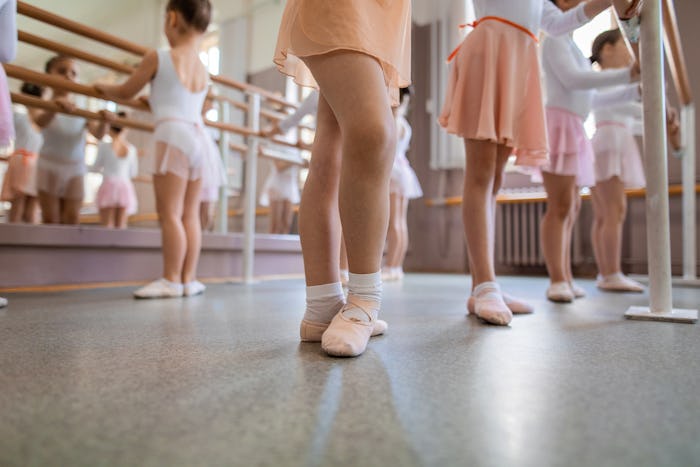 Beautiful and innocent ballet practicing children at a dancing studio.