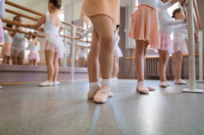 Beautiful and innocent ballet practicing children at a dancing studio.