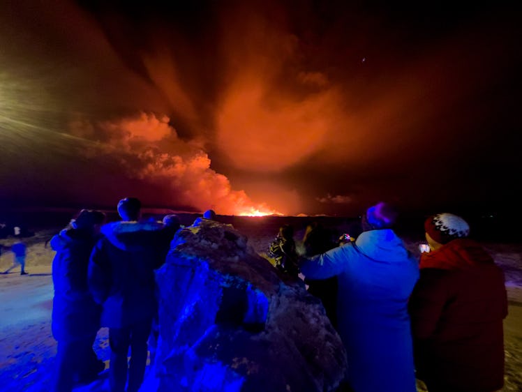 GRINDAVIK, ICELAND - DECEMBER 18: A volcano erupts on the Reykjanes Peninsula near the power station...